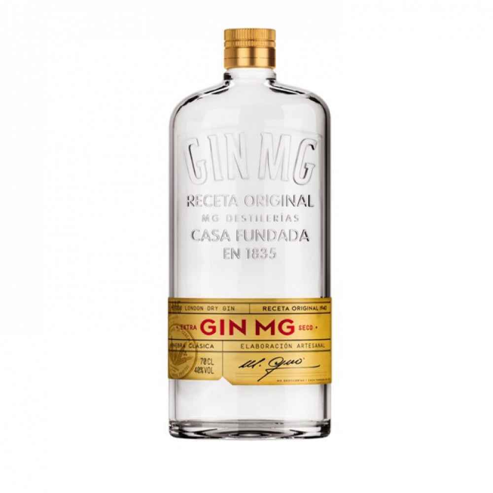 Clear bottle of Gin MG with gold cap and label on a white background