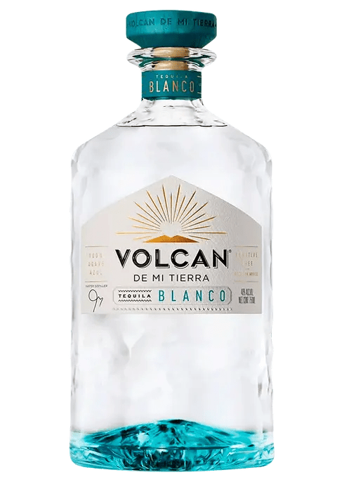 A bottle of Volcan De Mi Tierra Blanco Tequila with a clear liquid visible through the transparent bottle.
