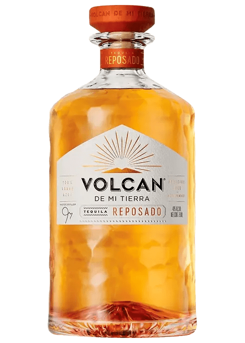 A bottle of Volcan Reposado Tequila with a clear label and orange cap.