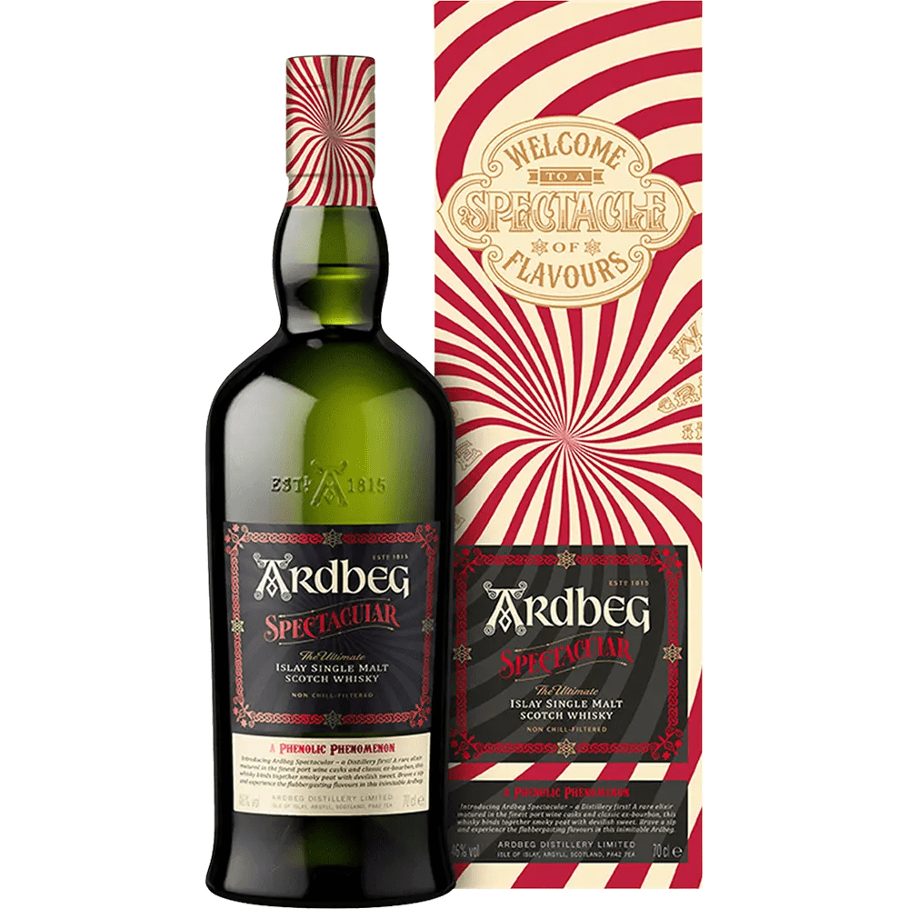 A bottle of Ardbeg Spectacular Single Malt Scotch with a colorful striped pattern on the label, next to its packaging box.
