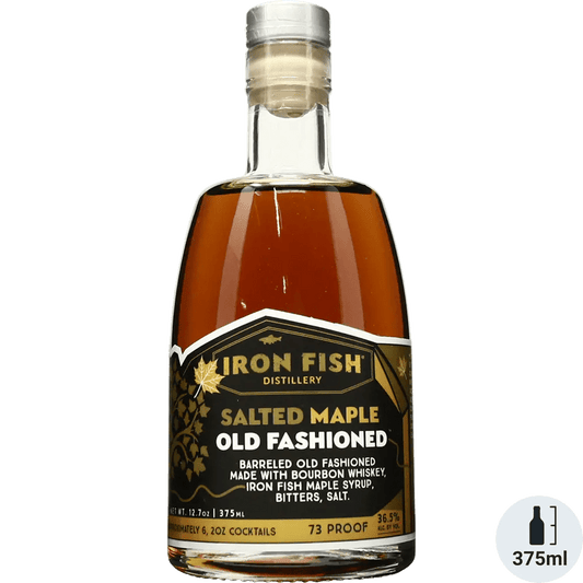 A bottle of Iron Fish Salted Maple Old Fashioned cocktail mix, with branding and text indicating the product is made with bourbon whiskey, maple syrup, bitters, and salt.