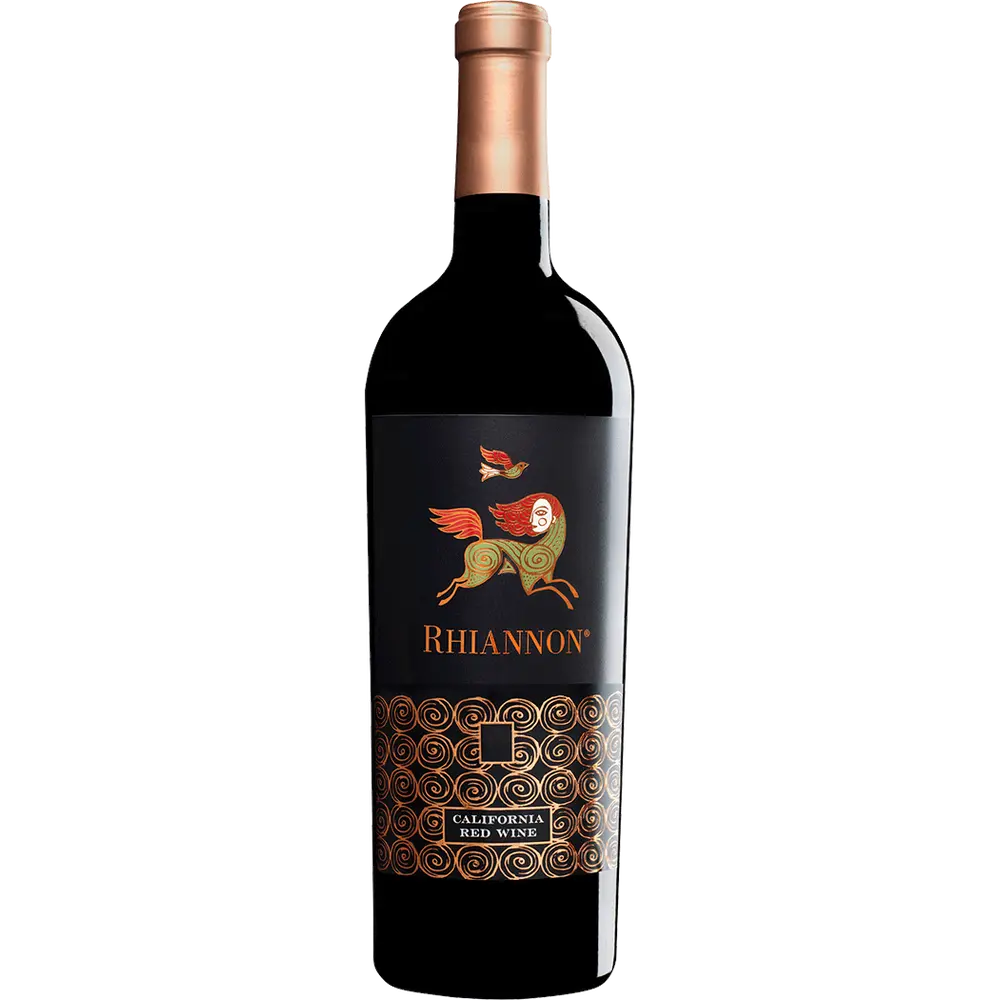 A bottle of Rhiannon red wine with a label featuring a golden bird in flight against a black background with ornate gold patterns.