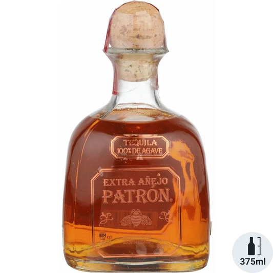Patron Extra Añejo tequila bottle with cork stopper on a white background
