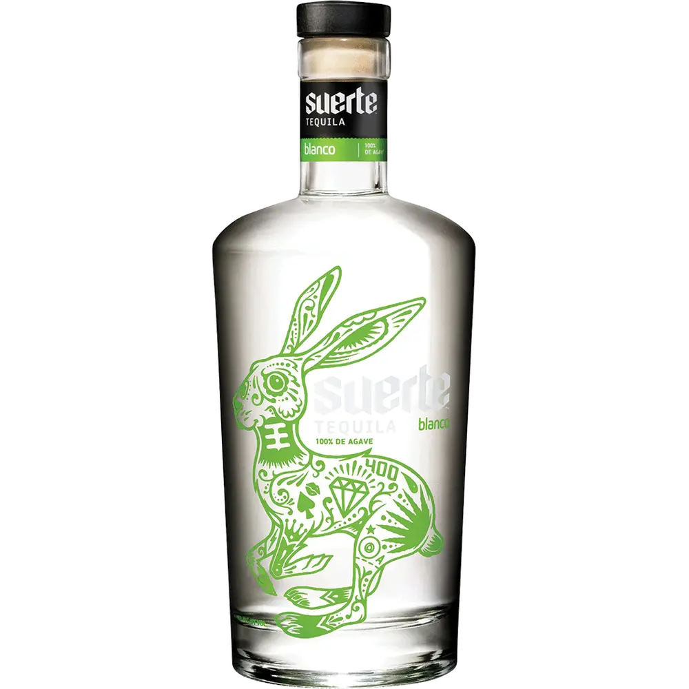 Clear tequila bottle with green rabbit illustration and 'suerte' branding on a white background