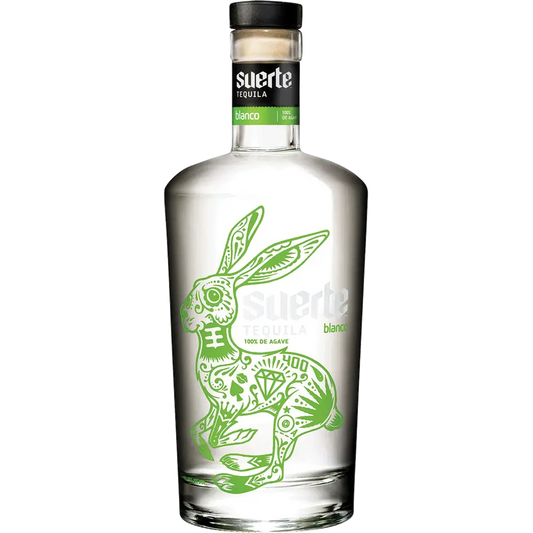 Clear tequila bottle with green rabbit illustration and 'suerte' branding on a white background