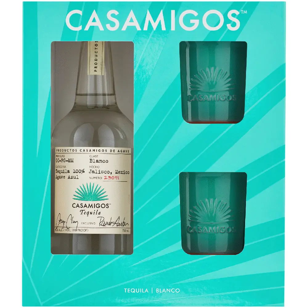 Casamigos tequila bottle and two glasses in a promotional package on a teal background