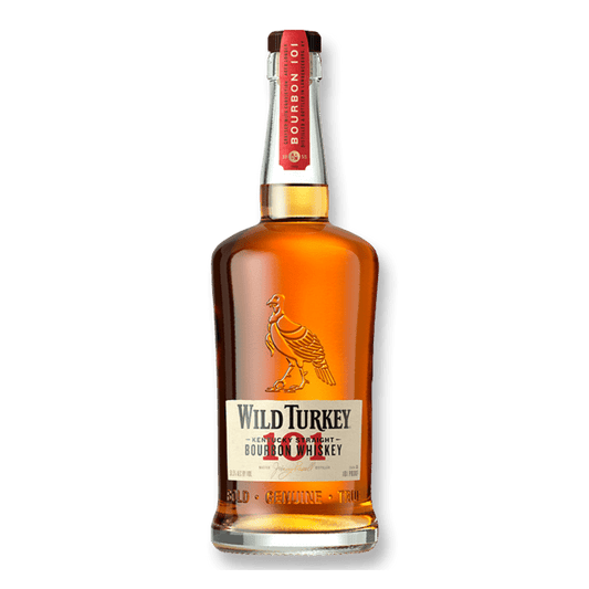 A bottle of Wild Turkey 101 Kentucky Straight Bourbon Whiskey with a charred oak barrel background.