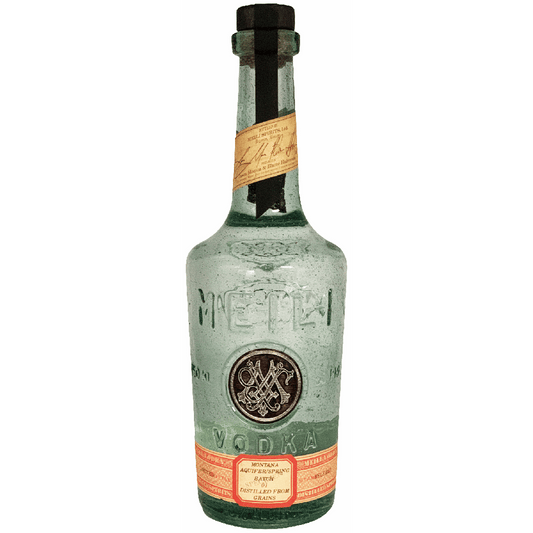 Vintage bottle of vodka with a label on a green background