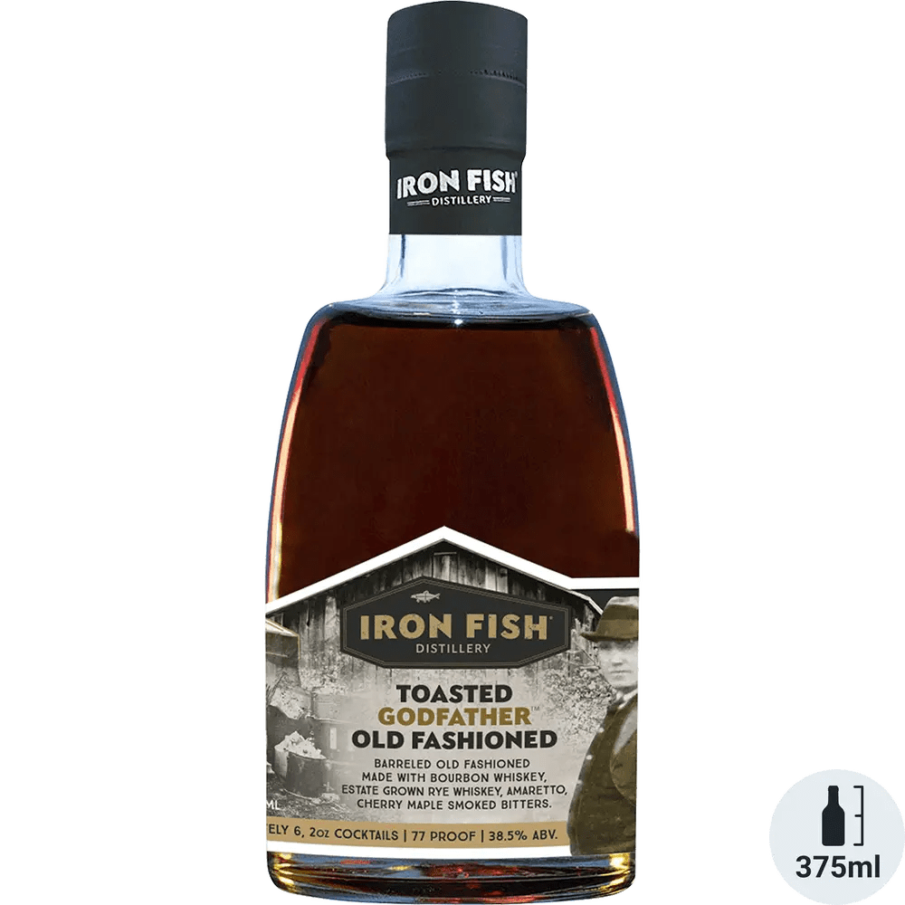 A bottle of Iron Fish Toasted Godfather Old Fashioned cocktail, displaying the liquid color and branding information on the label.
